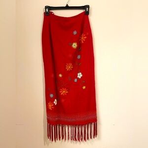 Linen skirt with fringe in the hemline Embroidered floral design in the front.